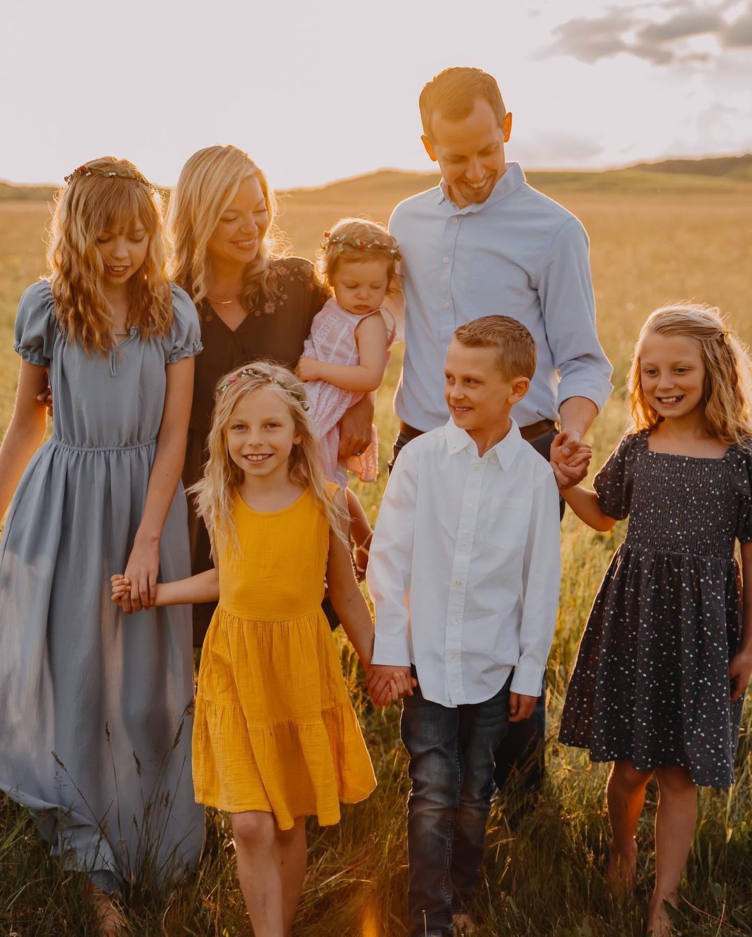 Matt with his family walking in a field smiling at each other